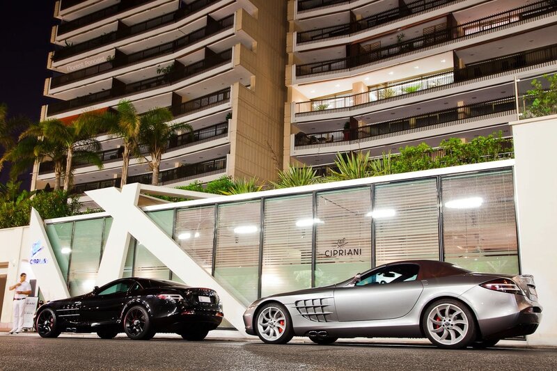 Two luxury cars at night