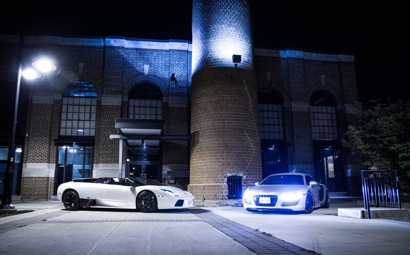 Two luxury cars at night