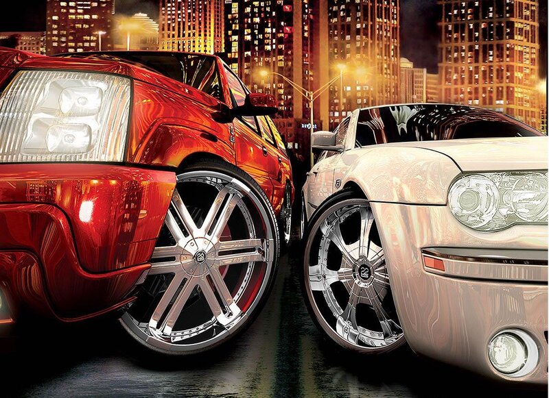 Two luxury cars at night