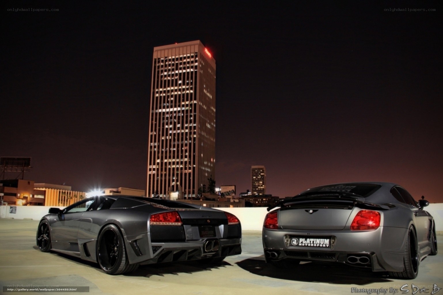 Two luxury cars at night