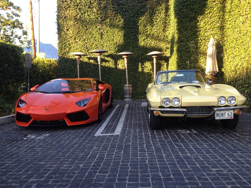 Two luxury cars parked