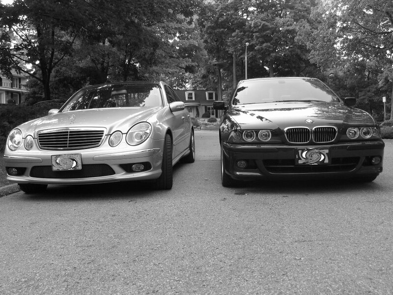 Two luxury cars parked side by side