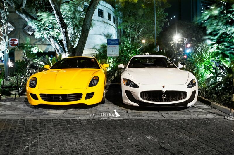 Two luxury sports cars at night