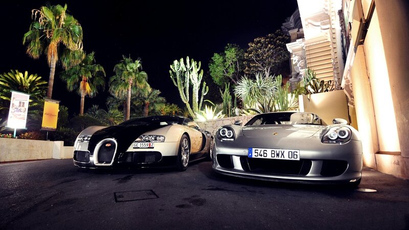 Two luxury sports cars at night