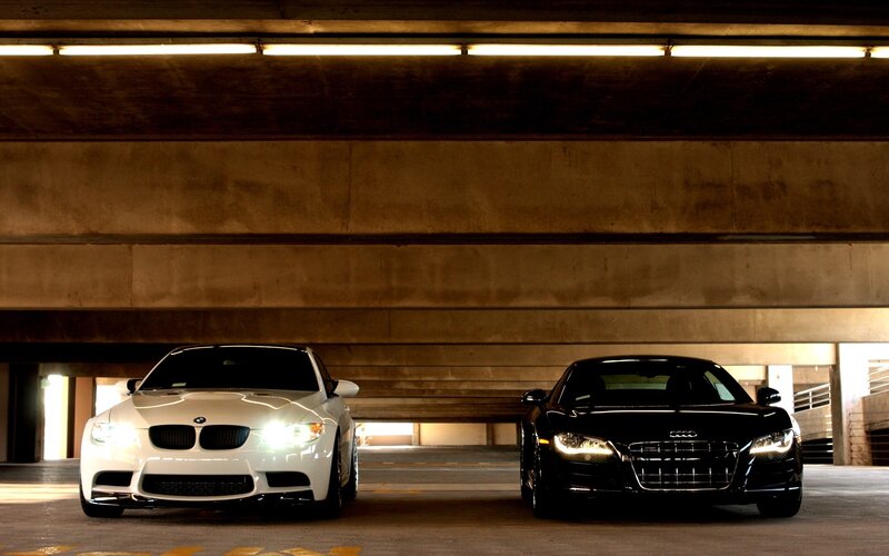 Two luxury sports cars in a garage