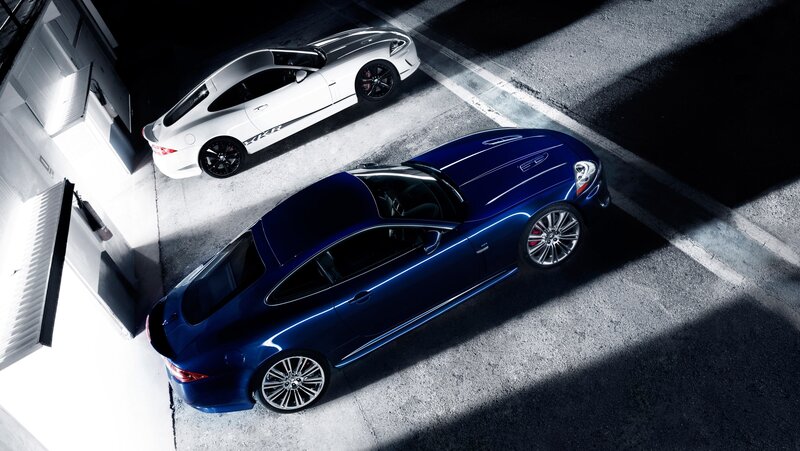 Two luxury sports cars in garage
