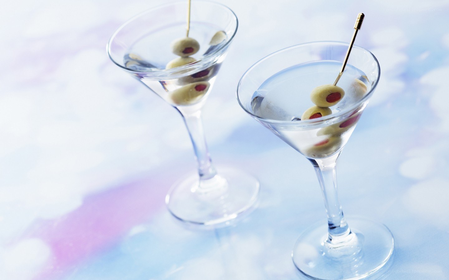 Two martini glasses with olives