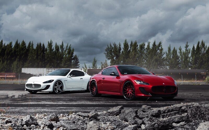 Two Maserati cars on a tarmac