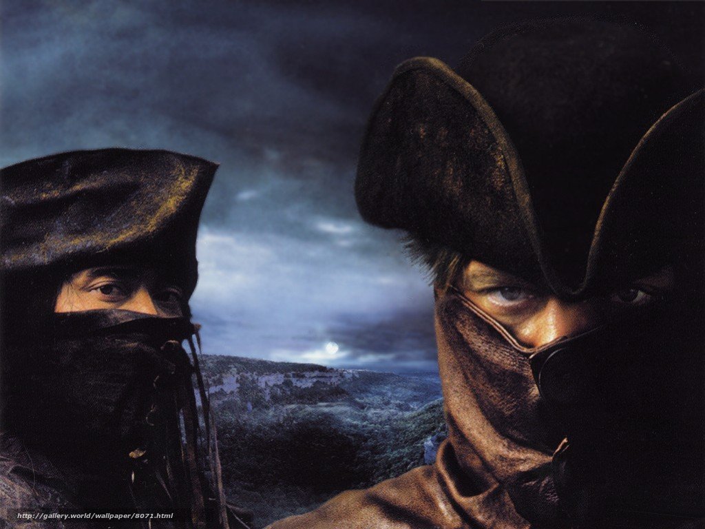 Two masked figures in a dark landscape