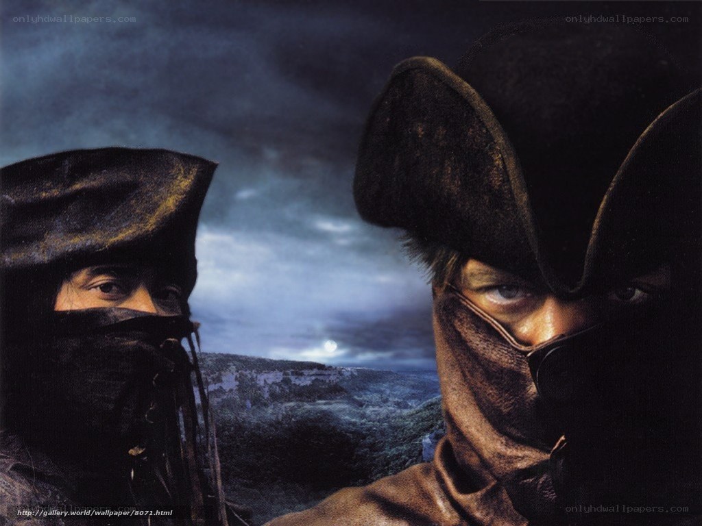 Two masked figures in a dark landscape