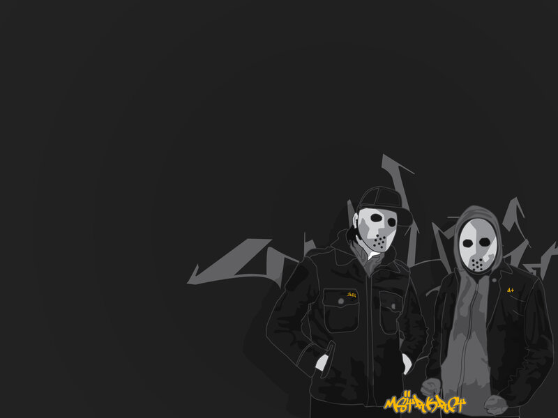 two masked figures in dark setting