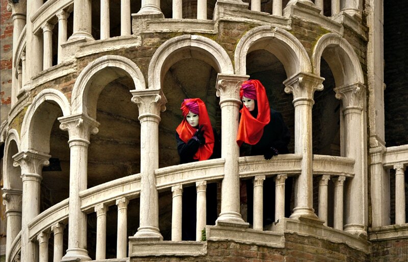 Two Masked Figures on Balcony