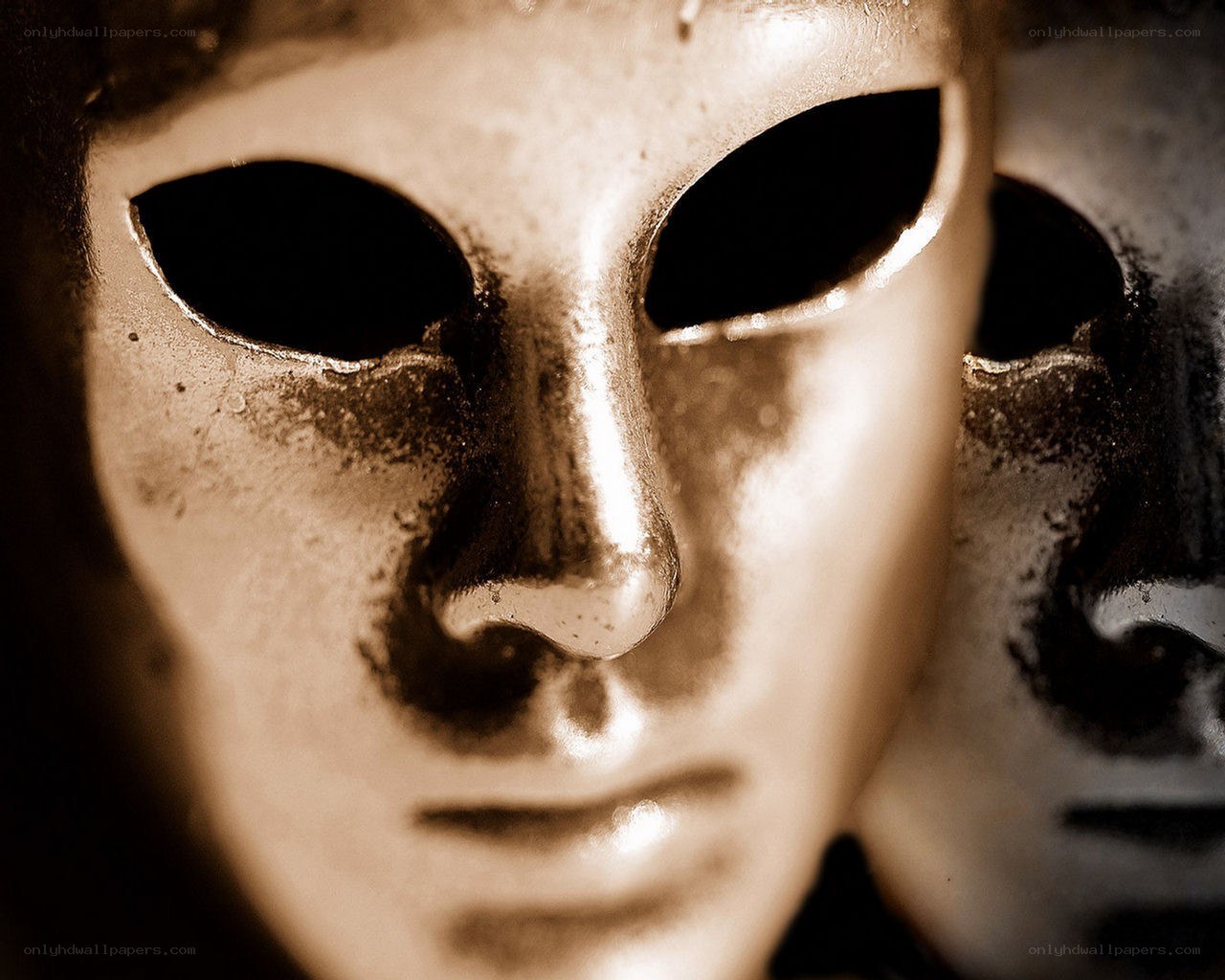 two masks in sepia