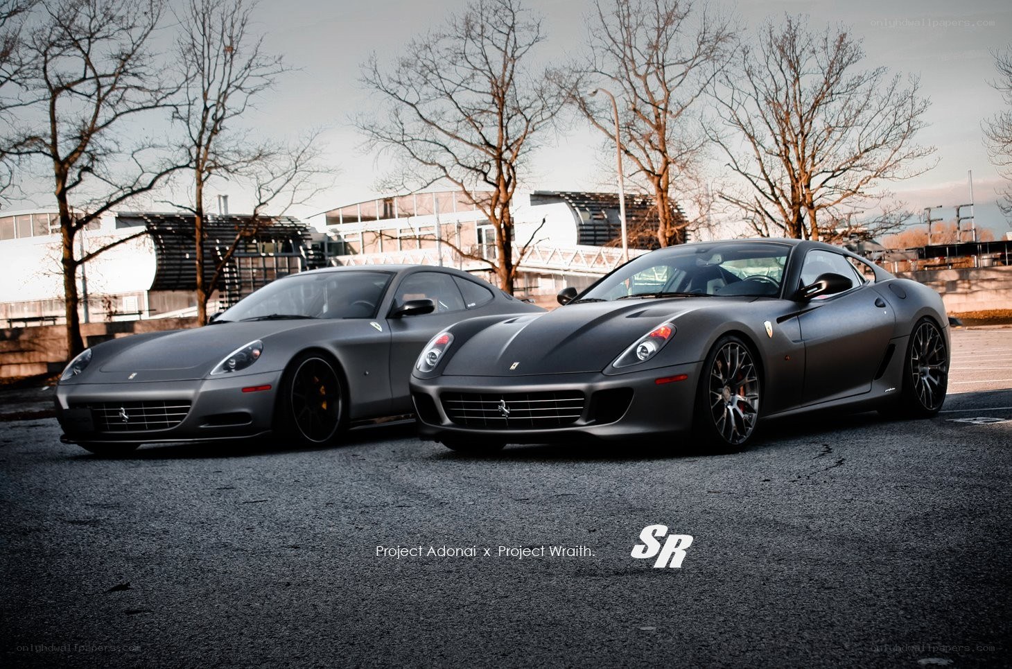 Two matte gray Ferraris parked