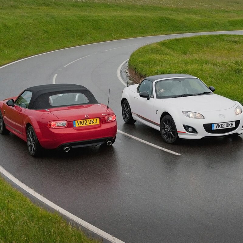 Two Mazda MX-5 cars on a road