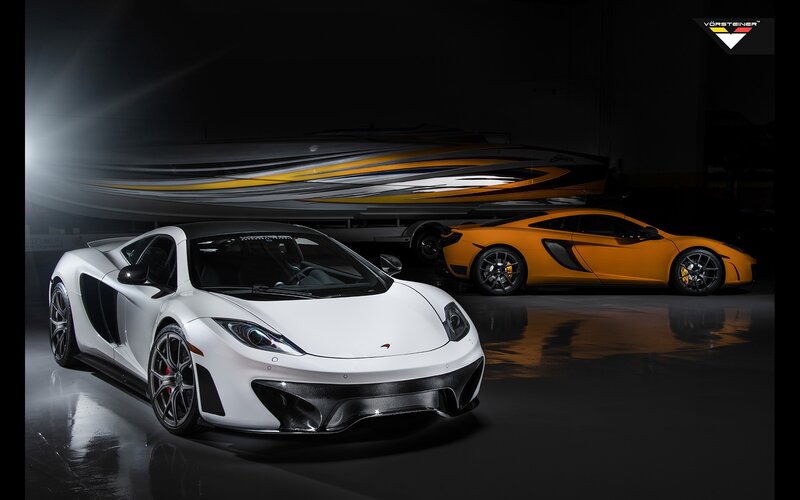 Two McLaren sports cars in a garage