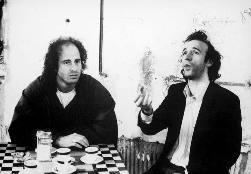 Two men at a cafe table