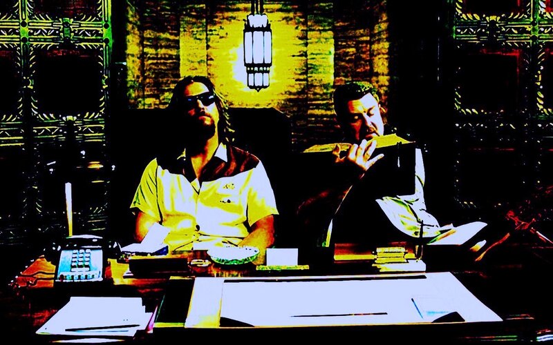 two men at a desk in an ornate room