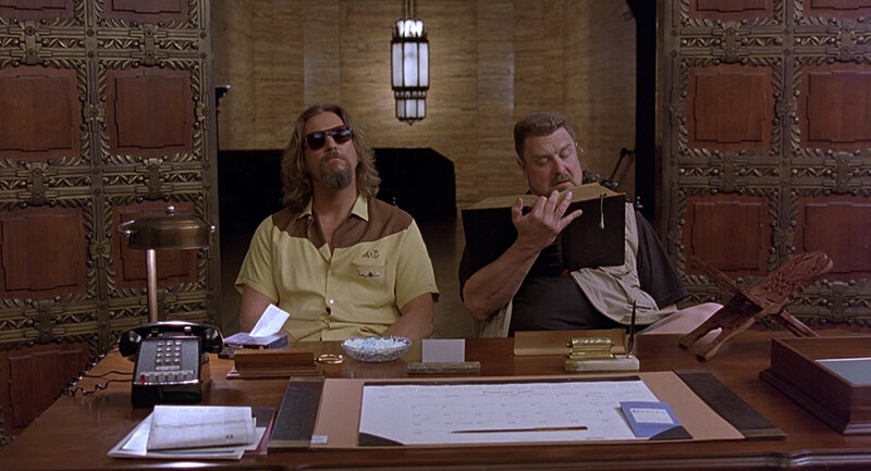 Two men at a desk in an ornate room