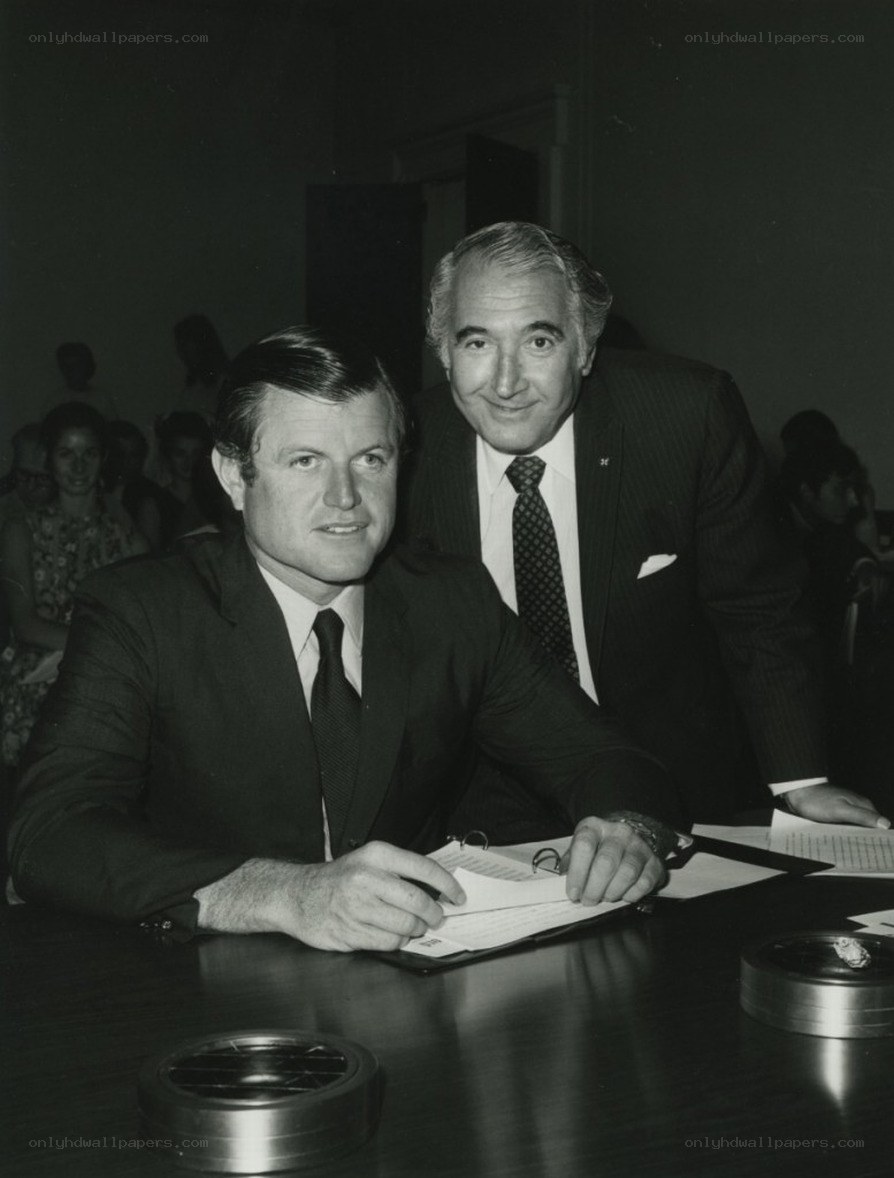 Two men at a table signing documents