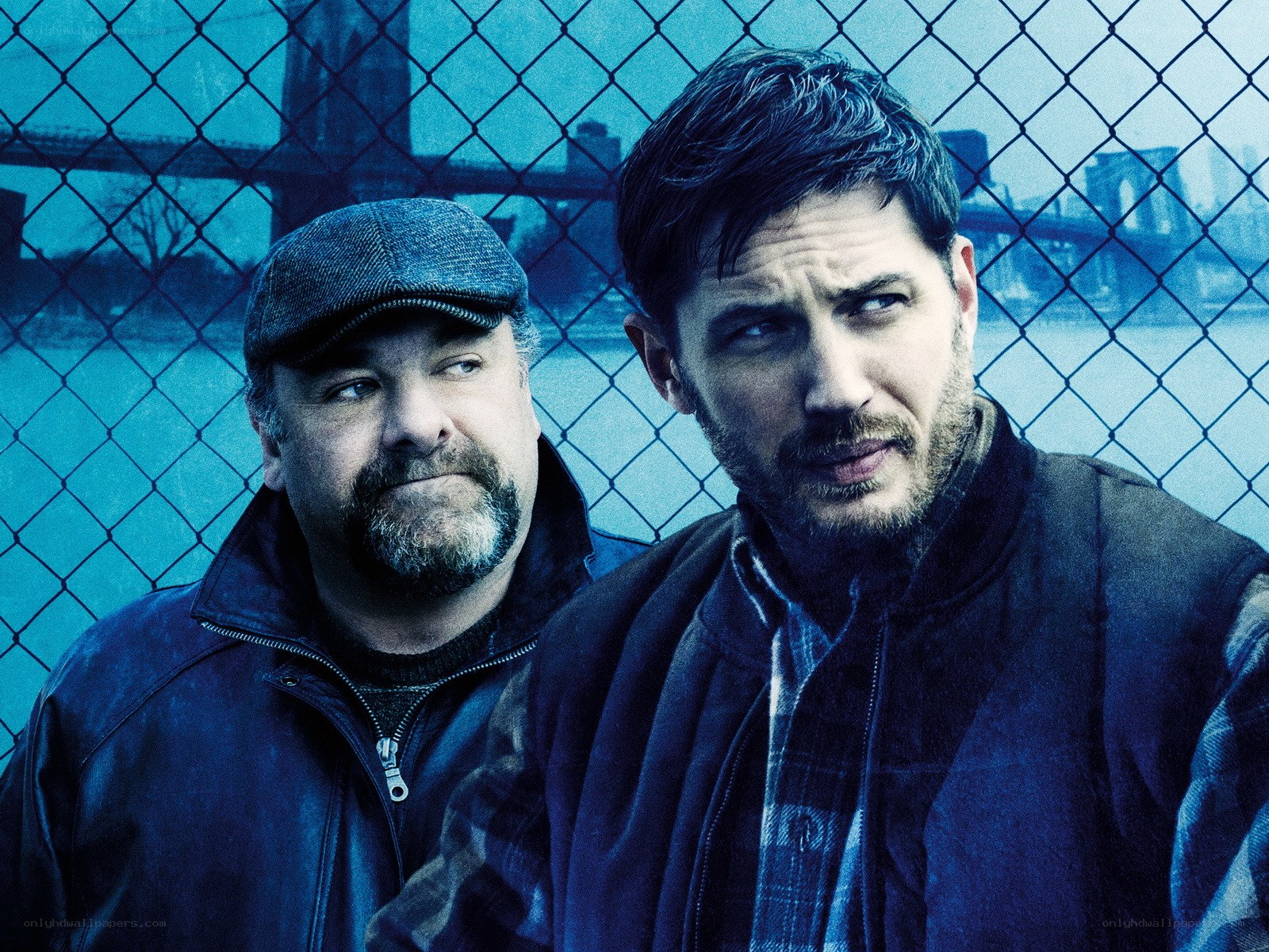 Two men behind a chain-link fence