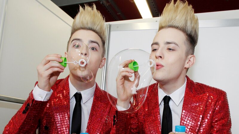 Two men blowing bubbles