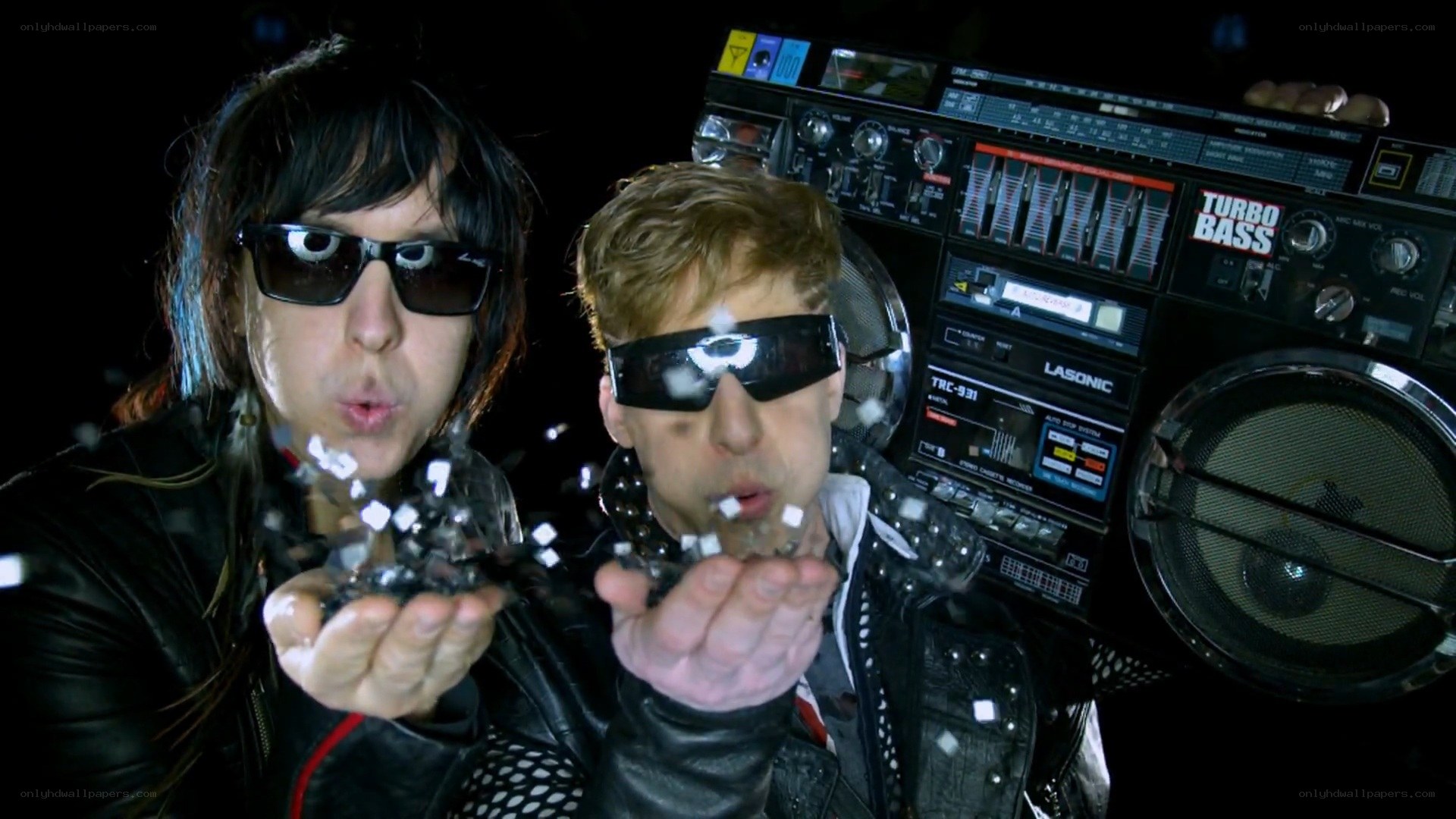 two men blowing confetti