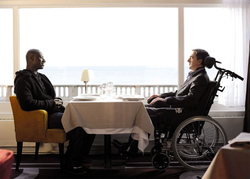 Two men conversing at a restaurant