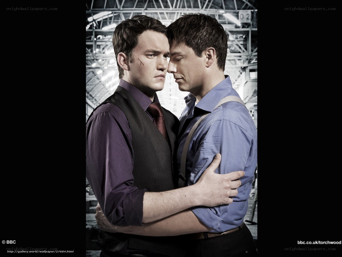 Two men embracing in an industrial setting