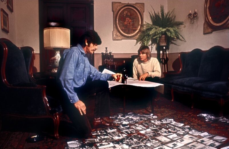 Two Men Examining Photos