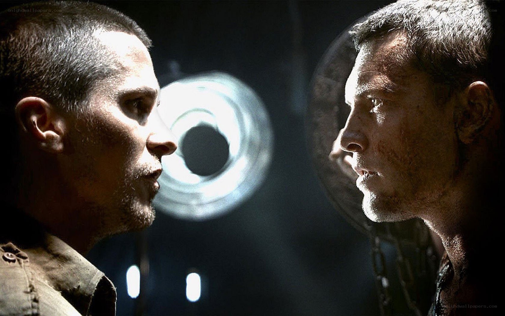 Two men face off in a dark room
