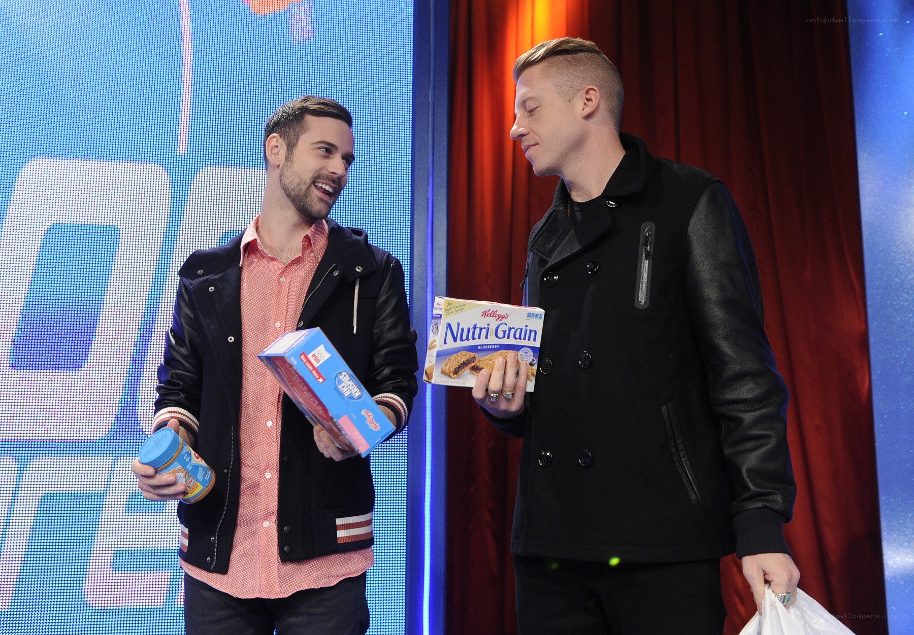 Two men holding food products