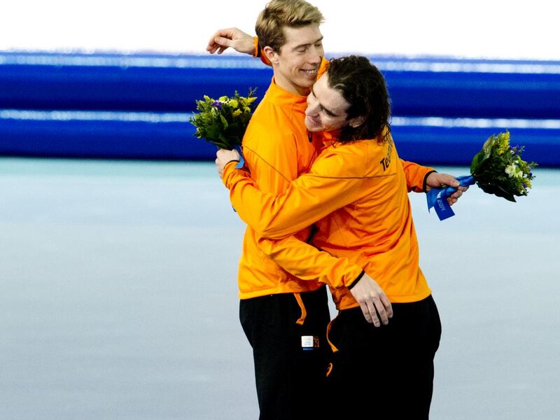 Two Men Hugging — Orange, Celebratory