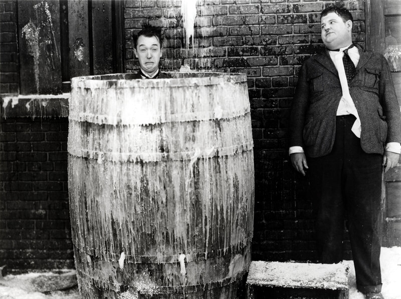 Two men in a barrel of ice water