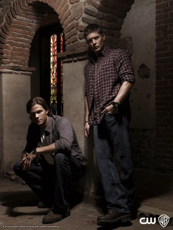 two men in a brick hallway