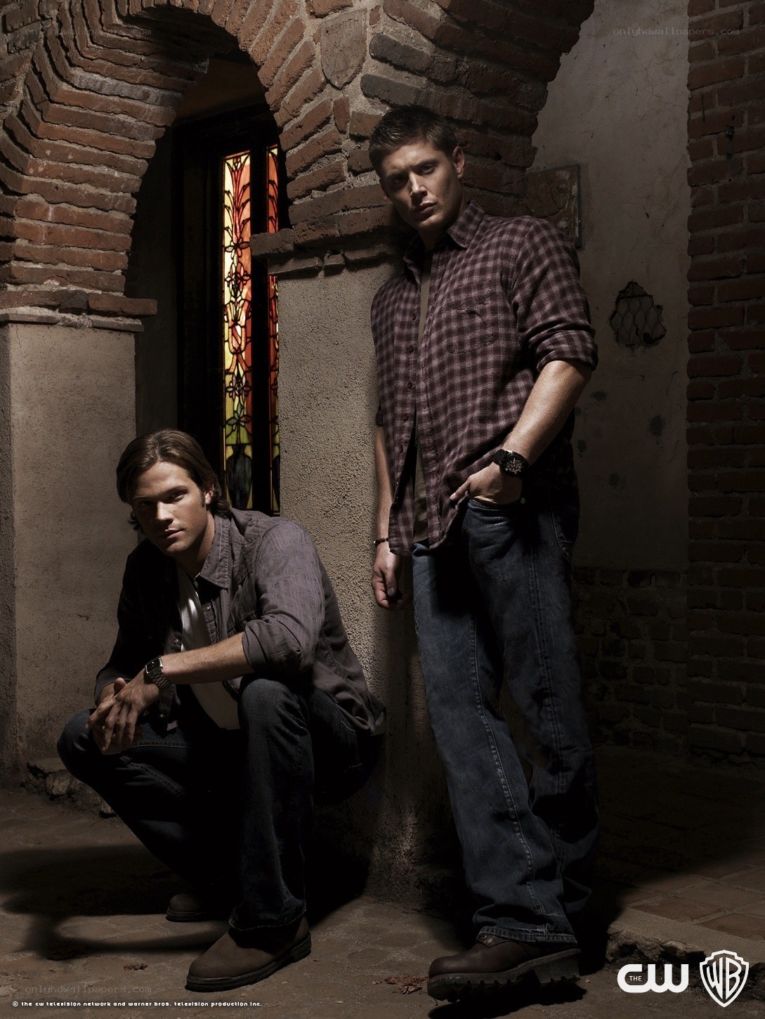 two men in a brick hallway