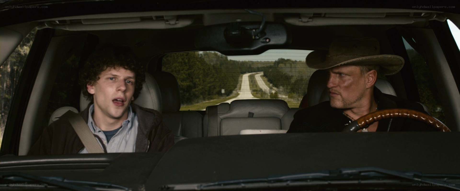 Two men in a car on a road