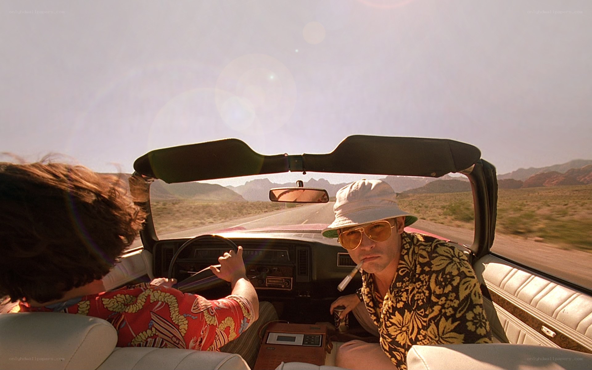Two men in a convertible car