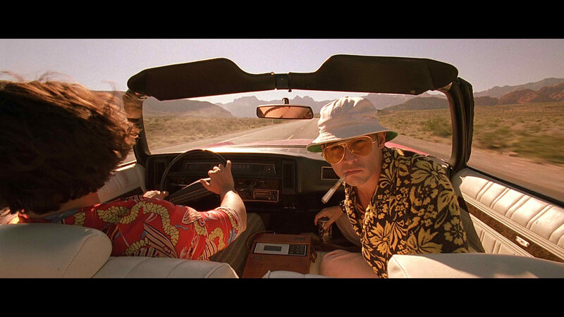 Two men in a convertible car
