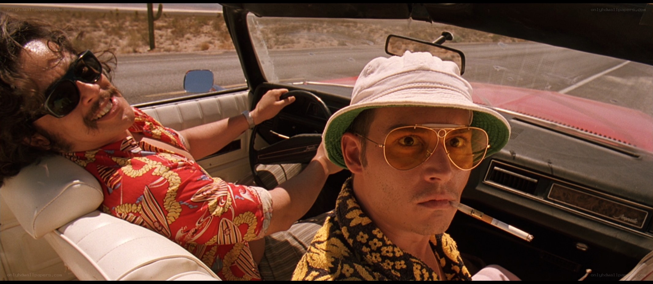 two men in a convertible car