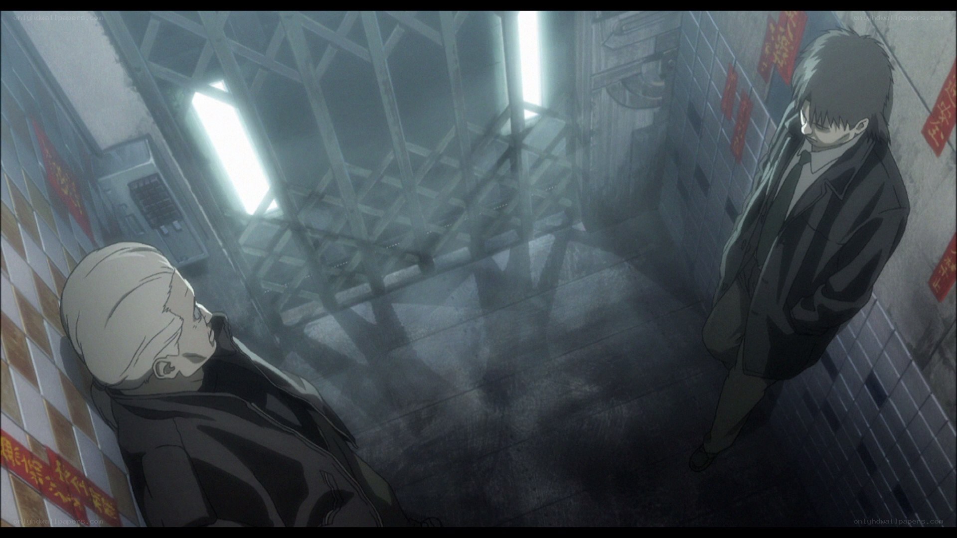 two men in a dim hallway