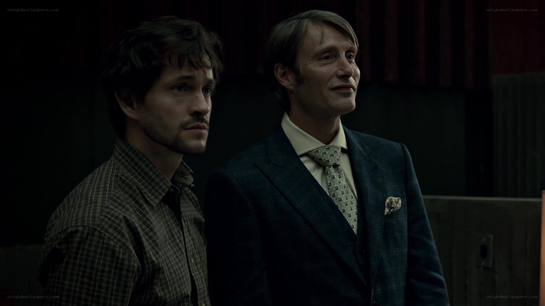 two men in a dimly lit room