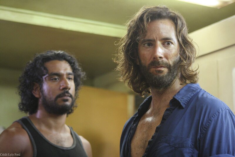 Two men in a dimly lit room