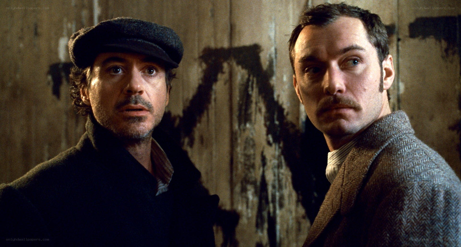 Two men in a dimly lit room