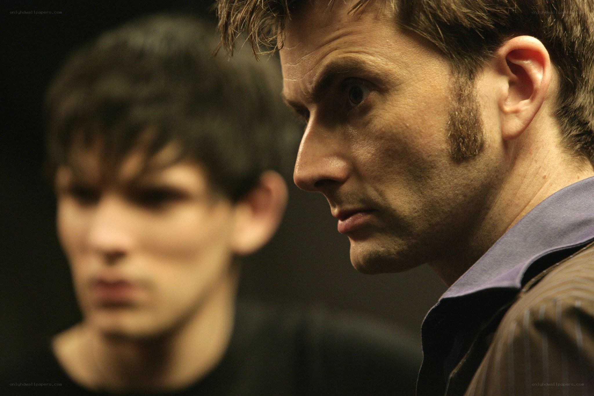 Two men in a dimly lit room