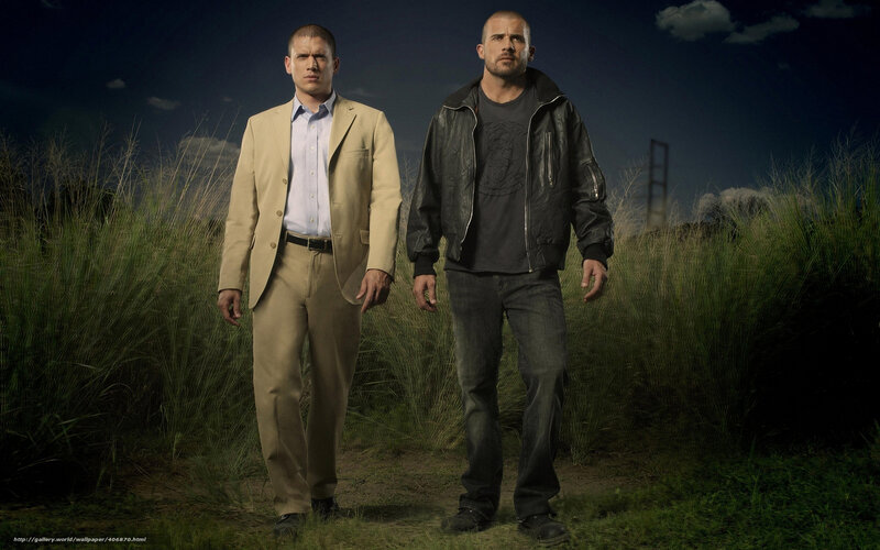 Two men in a field at night