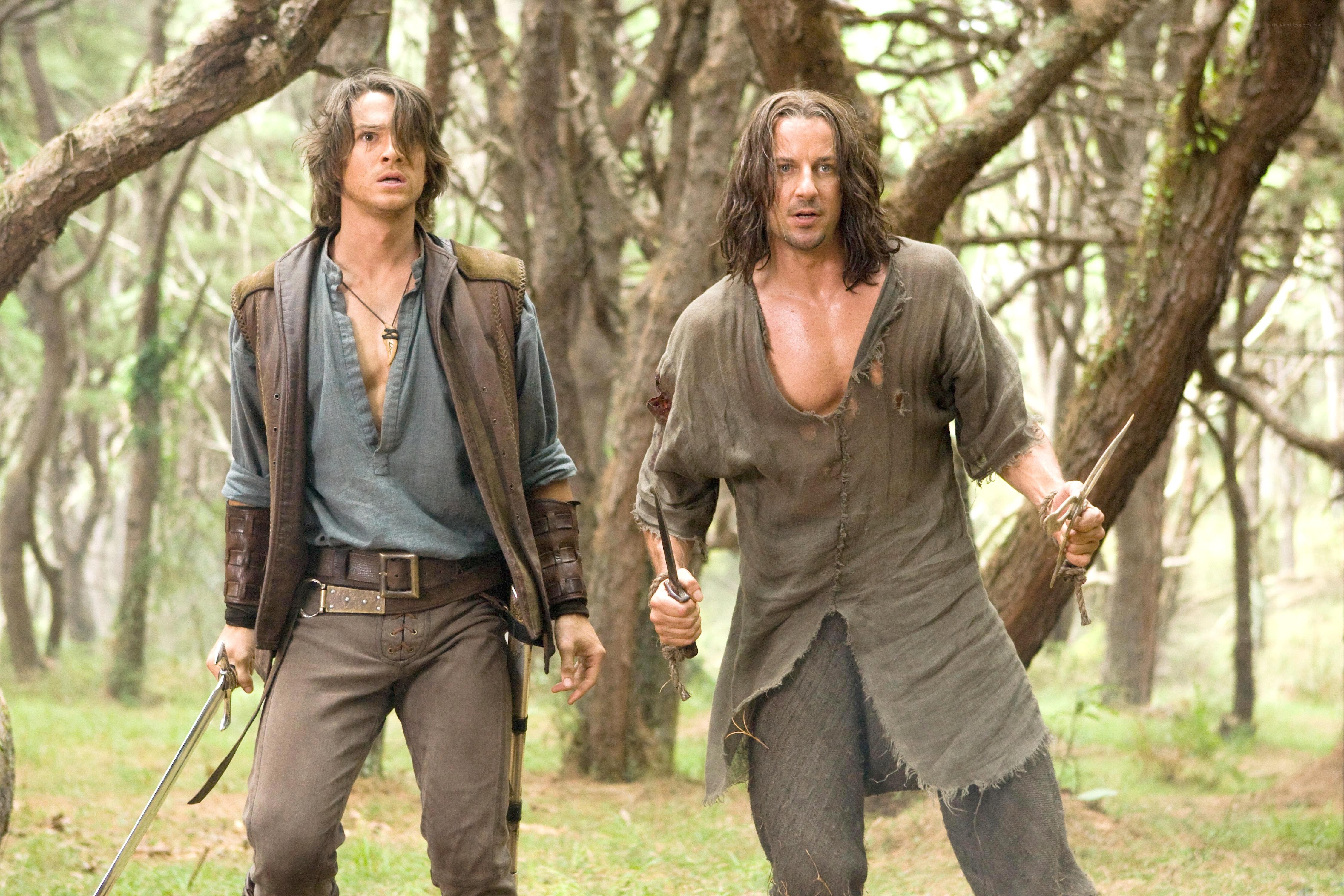 Two men in a forest with swords