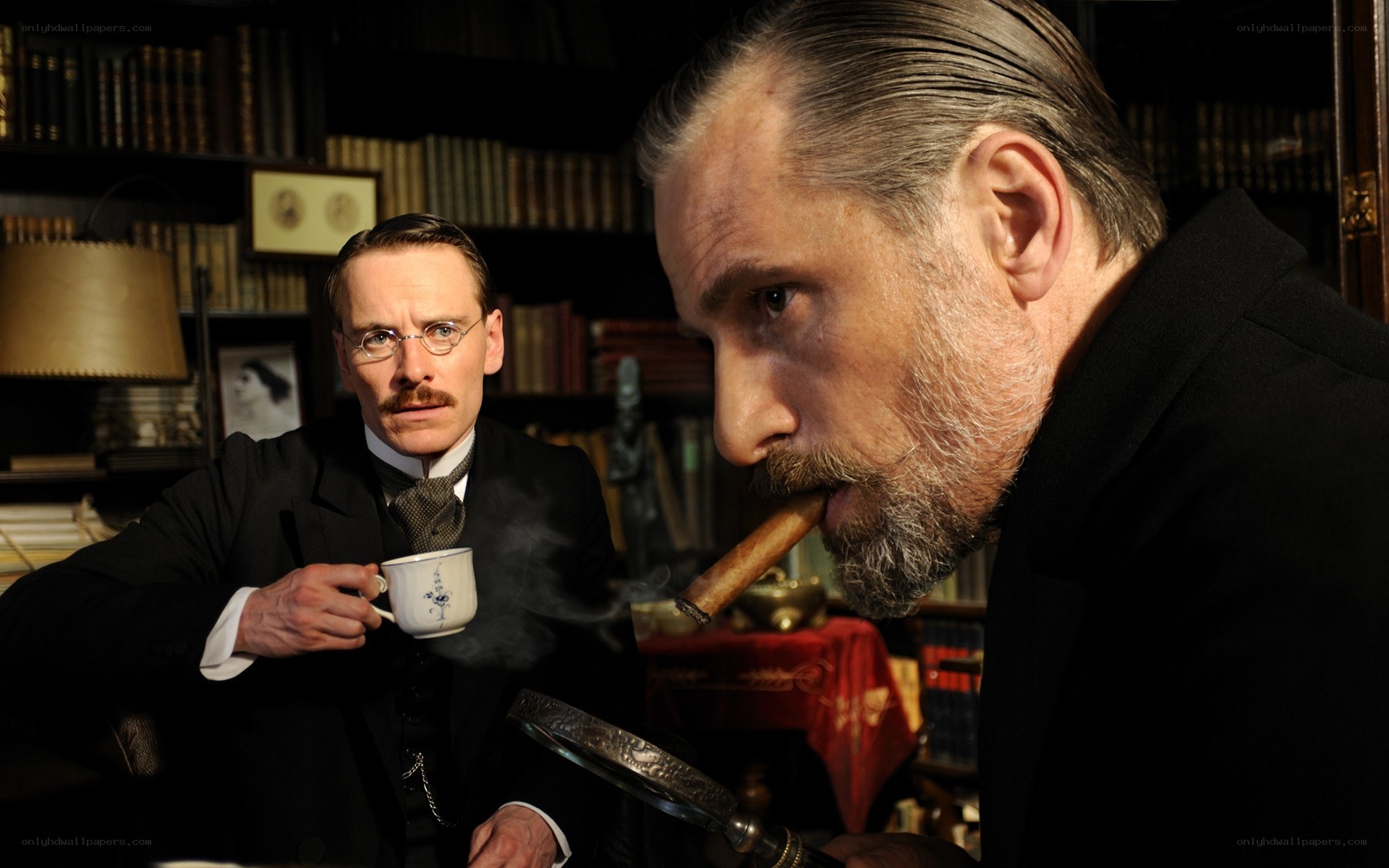 Two men in a study with pipe and tea