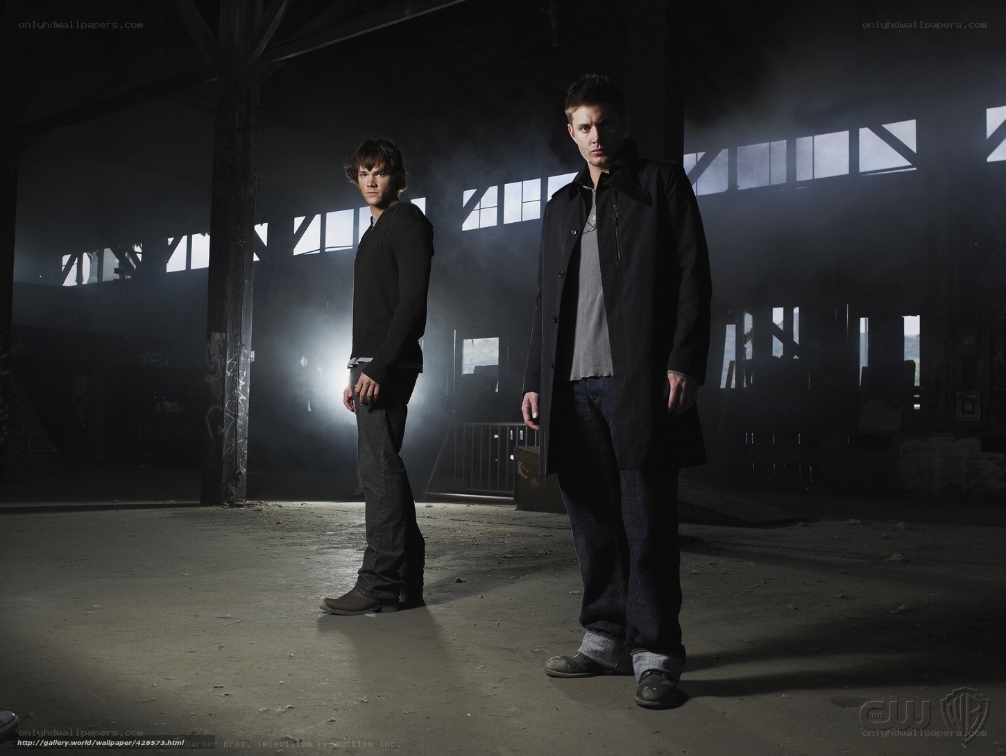 two men in an abandoned warehouse