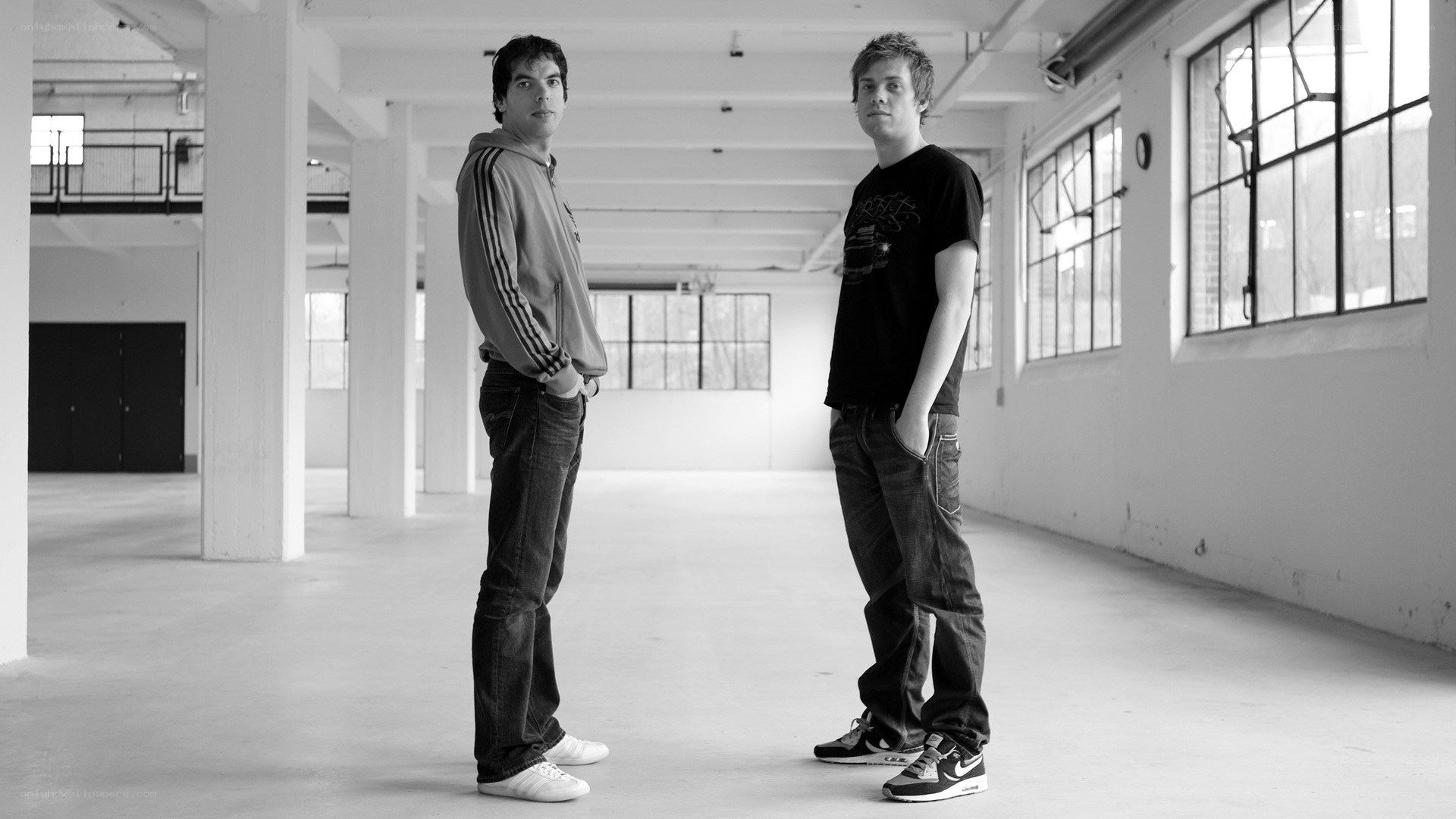 two men in an empty warehouse